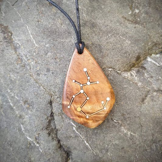 Sagittarius Pendant on Swamp Kauri with Metal Inlay in the shape of the constellation.