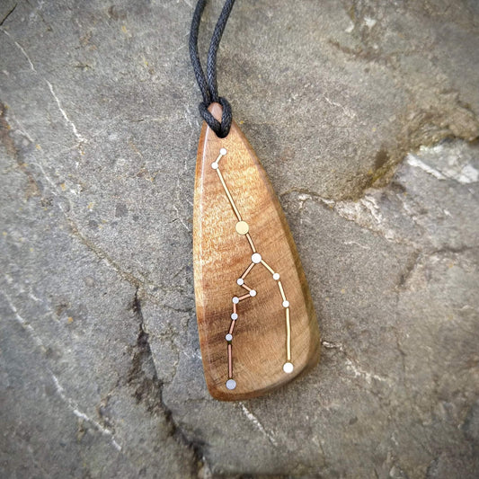 Taurus Pendant on Swamp Kauri with Metal Inlay in the shape of the constellation.